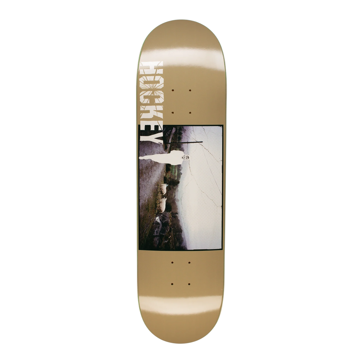 A skateboard deck with a metallic gold base, featuring a large central graphic print of a cracked wall and the brand name 'HOKSE' printed vertically in white on the nose.