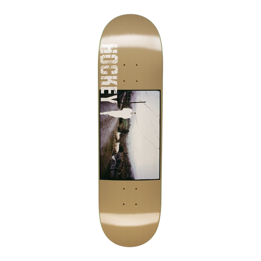 A skateboard deck with a metallic gold base, featuring a large central graphic print of a cracked wall and the brand name 'HOKSE' printed vertically in white on the nose.