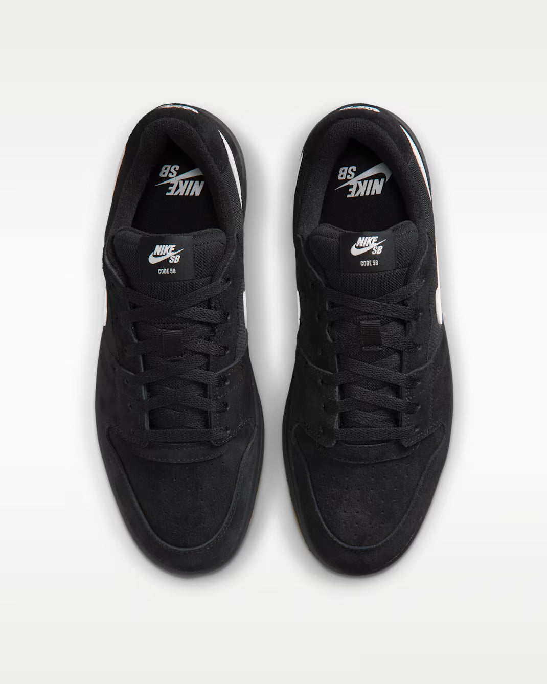 A pair of black Nike SB 80th Anniversary sneakers shown from a top-down view on a light gray background.