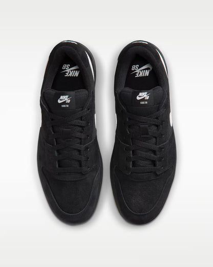 A pair of black Nike SB 80th Anniversary sneakers shown from a top-down view on a light gray background.