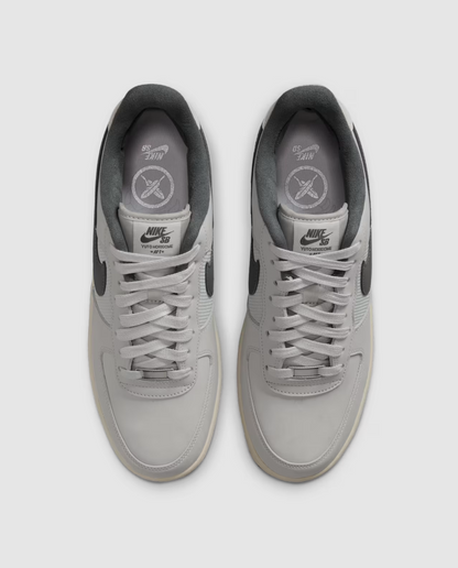 A pair of Nike Air Force 1 Low sneakers in light gray, shown from a top-down view on a light gray background.